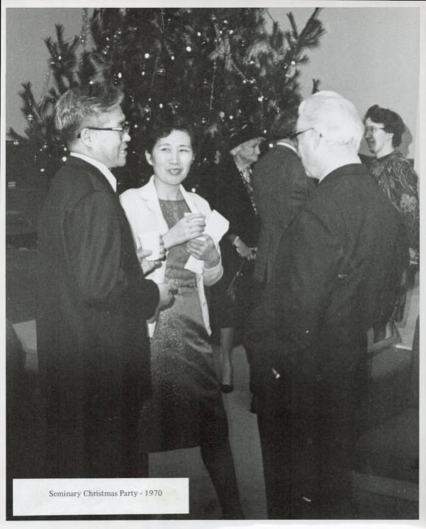 Three people mingling at seminary Christmas party in 1970.