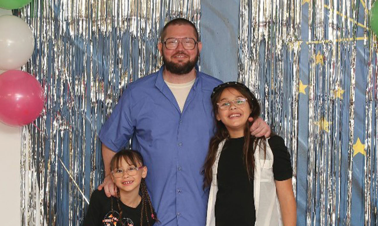 Three people smiling for the camera at a celebration