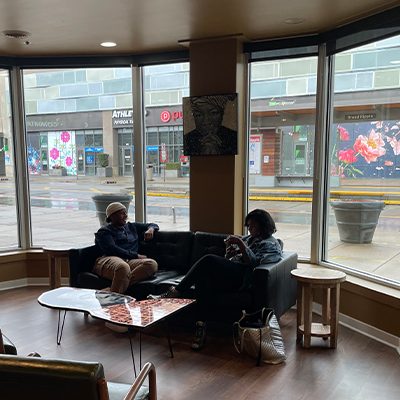 Two patrons enjoy a brief respite at the grand opening of The Avenue Coffeeshop and Café in Indianapolis.