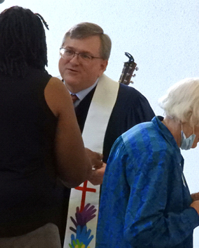 Rev. Dr. Scott Seay giving communion at chapel