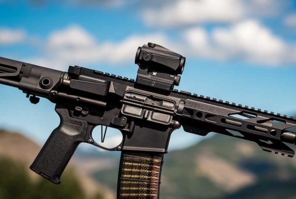 An assault rifle with mountains and sky in the background