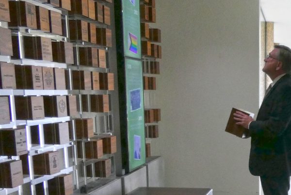 Rev. Dr. Scott Seay placing his block on the donor wall