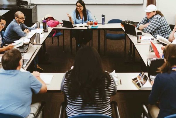 Group of students gathered around the table for a discussion.
